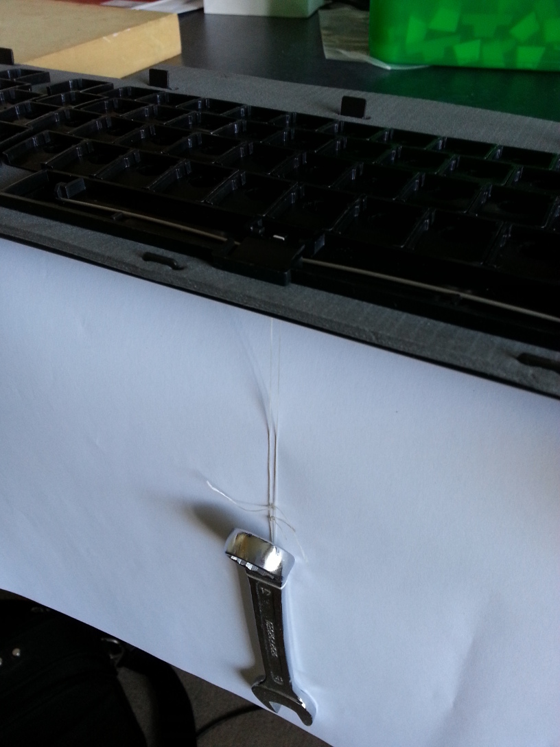 Holding the flipper for the space-bar in place during assembly.