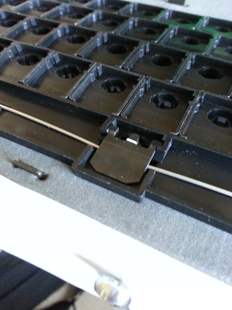 Detail of the floss holding the flipper in place