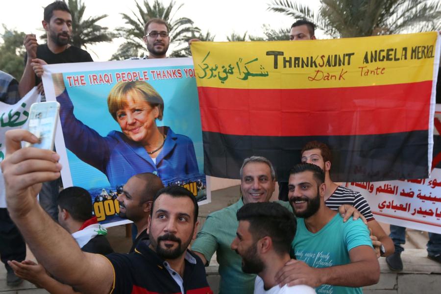Iraqi-protesters-take-a-selfie-with-a-po.jpg