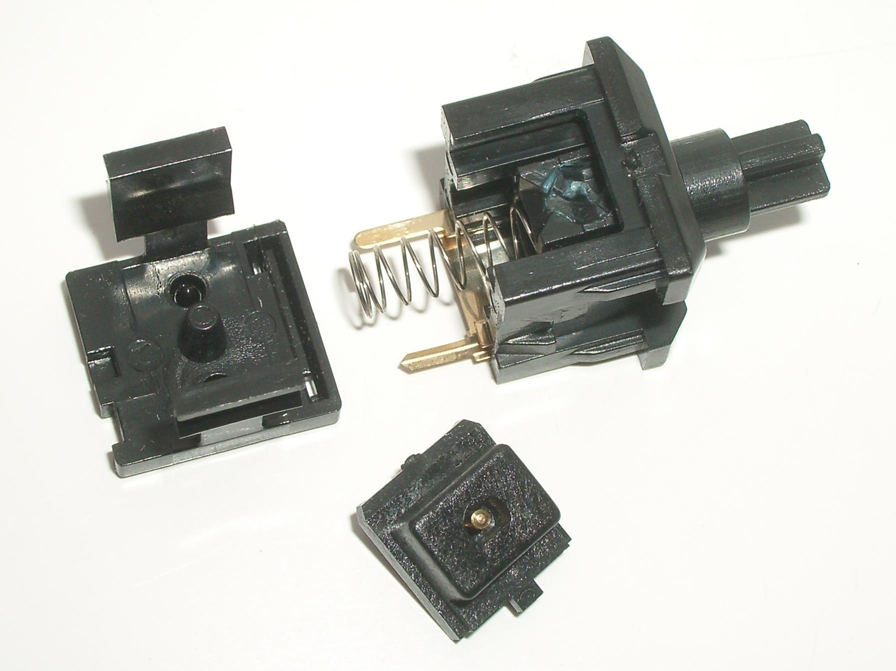 Note the different plastic textures, as well as the blue lubricant used in the latch track.