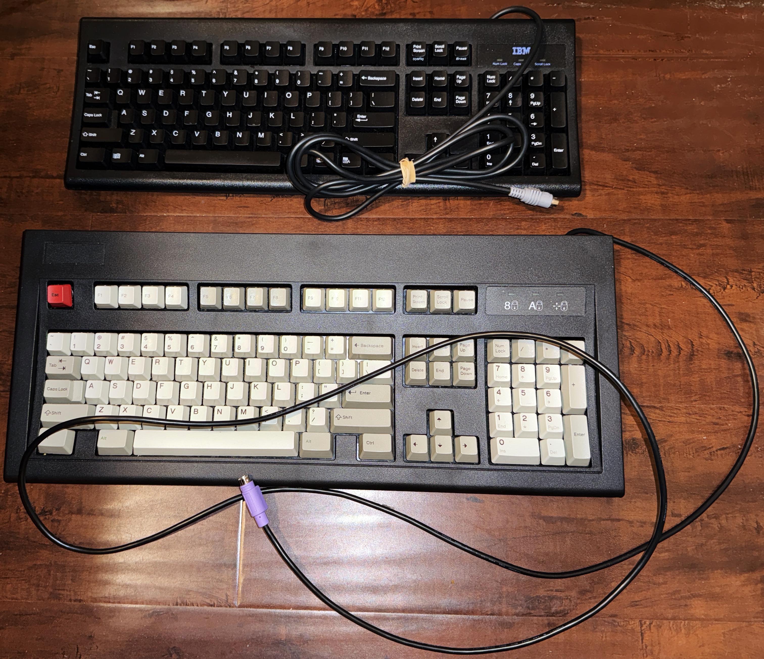 The top is a 1996 Chicony KB-8923 (rebranded as IBM). It's pretty great to type on. I'd rate it as the second-best &quot;rubber dome&quot; keyboard I've used. The bottom is a Unicomp Classic. There's no label on the case, but I'd estimate it to be have been made between 2018 and 2023. I discarded the Unicomp keycaps and replaced them with a set of one-piece keycaps (1995) from Lexmark. For a smoother typing feel.<br /><br />.